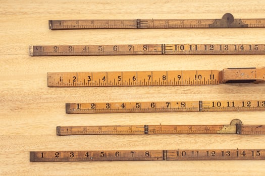 Group of Old wooden ruler on table Measuring or accuracy concept photo