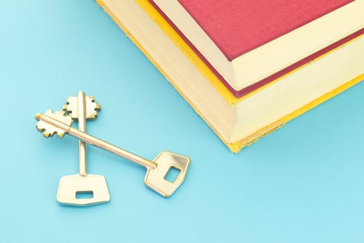 Book and keys on blue background photo