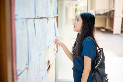 A female university student is exciting with the exam report photo