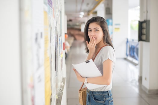 A female university student is exciting with the exam report photo