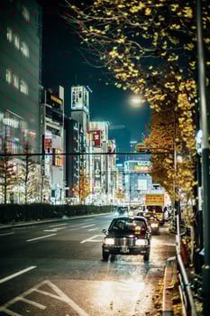 Black car on Tokyo street at night photo