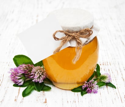 Jar of honey with clover photo