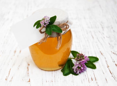 Jar of honey with clover photo