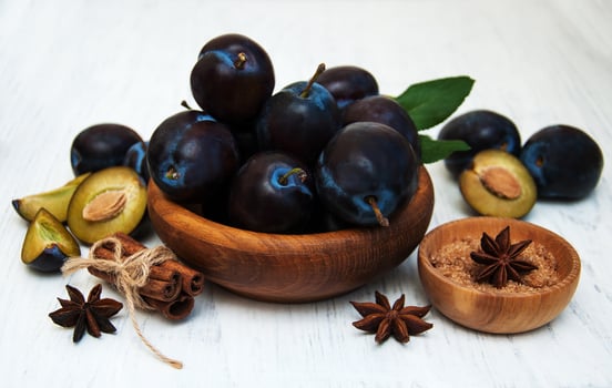 Sweet plums on a wooden background photo