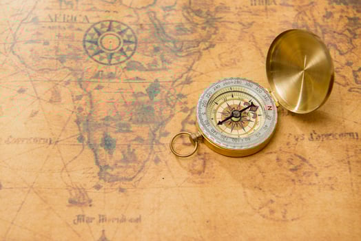 Old compass on vintage map photo