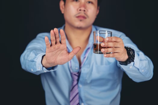Handsome handsome man drinking whisky at home photo