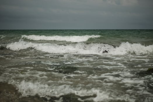 turquoise waves of a raging ocean on the summer beach photo