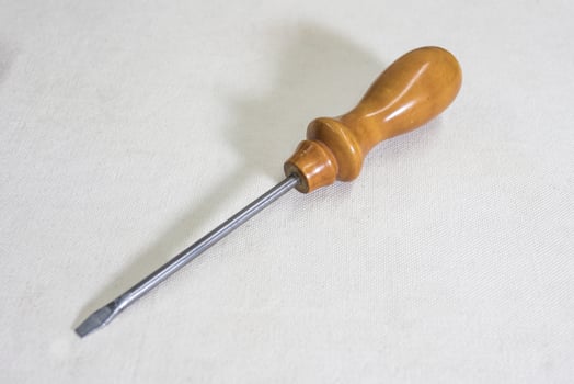 screwdriver with wooden handle on white background copy space photo