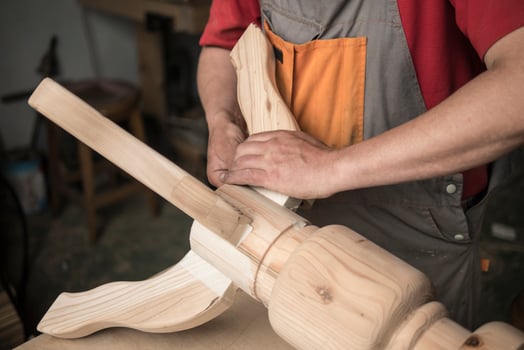 carpenter makes a table with carved legs photo