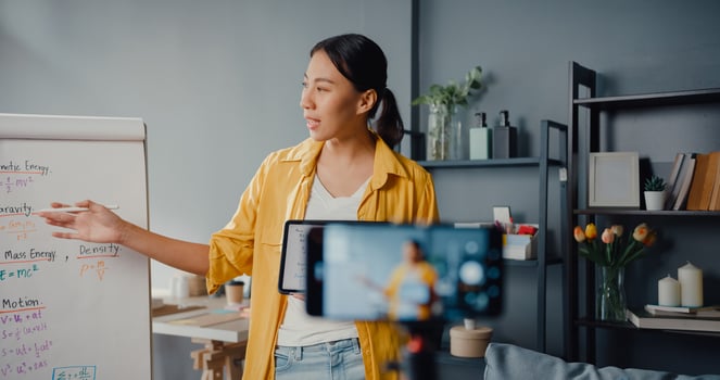 Young Asia lady teacher video conference calling on smartphone talk by webcam learn teach in online chat at home photo