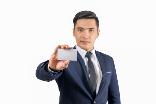 Handsome businessman holding blank business card isolate on white background photo