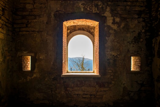 View of trees and mountains through an old window photo