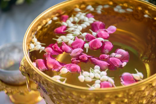 Water in water dipper with colorful flowers pedestal for Songkran festival, Thailand photo