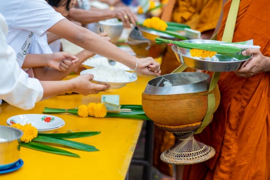 Alms round The yellow robes of monks walk on alms round as a Buddhist activity. photo
