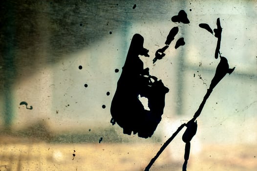 Apstract black shape on a dirty glass with an abandoned blurry interior background photo