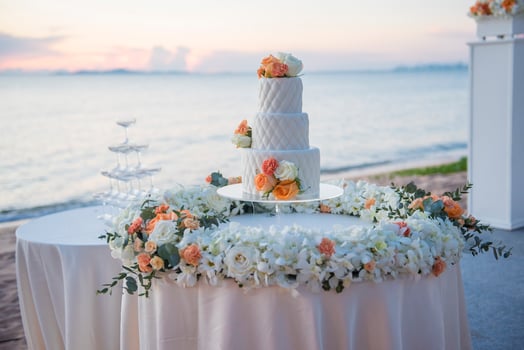 Wedding cake at sunset beach wedding photo