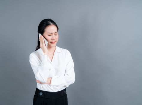 Asian woman using mobile phone talking business photo
