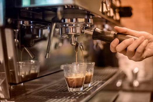 Barista making espresso drinks photo