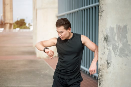 Sport man checking time at outdoor city photo