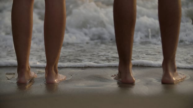 Couple standing at sea shore photo