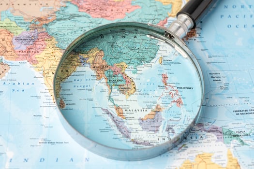 Bangkok, Thailand - November 01, 2020 Asia, Magnifying glass close up with colorful world map photo