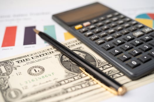 Pen and calculator on chart or graph paper. Financial, account, statistics and business data concept. photo