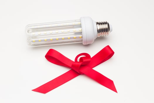 Energy-saving bulb with a red ribbon photo