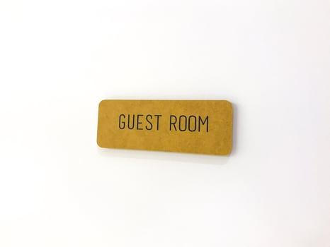 Yellow sign on the white door. Guest room photo