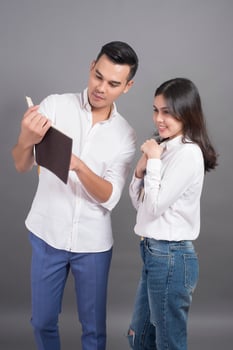Two young people in white shirts and grey background photo