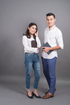 Two young people in white shirts and grey background photo
