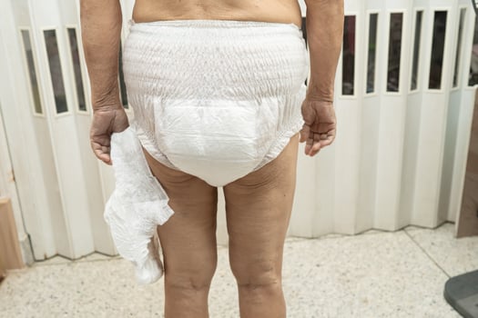 Asian senior or elderly old lady woman patient wearing incontinence diaper in nursing hospital ward, healthy strong medical concept. photo
