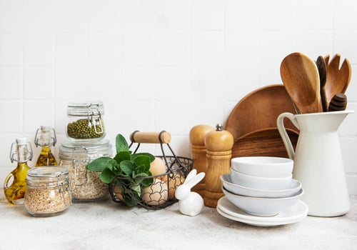 Kitchen utensils, tools and dishware on on the background white tile wall photo