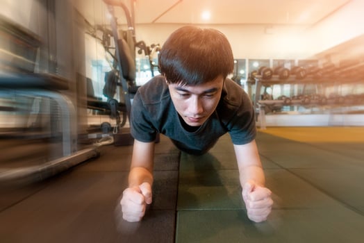 Fitness man is planking in the gym photo