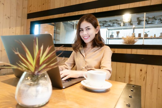 Beautiful business woman is working with her laptop in coffee shop photo