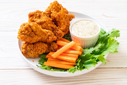 Fried spicy chicken wings with vegetable photo