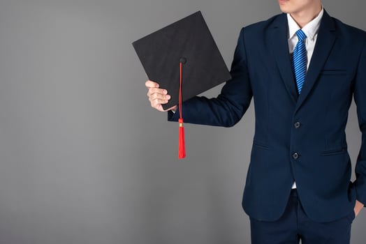 business man is holding graduation hat, business education concept photo