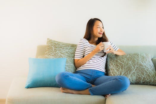 Portrait beautiful young asian woman on sofa with coffee cup photo