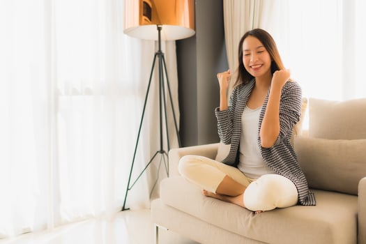 Portrait beautiful young asian women happy smile relax sitting on sofa chair photo
