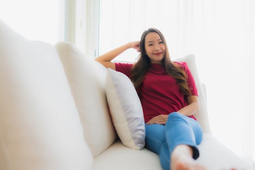 Portrait beautiful young asian women happy smile sit on sofa photo