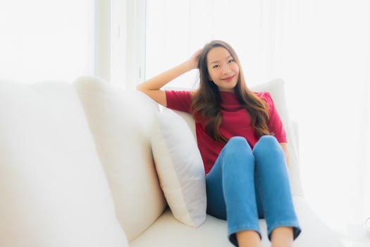 Portrait beautiful young asian women happy smile sit on sofa photo