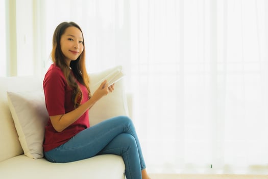 Portrait beautiful young asian women read book on sofa chair photo