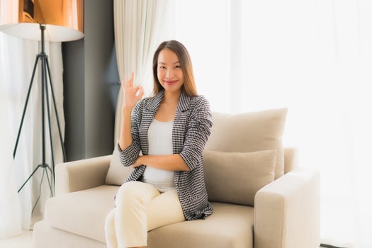 Portrait beautiful young asian women happy smile relax sitting on sofa chair photo