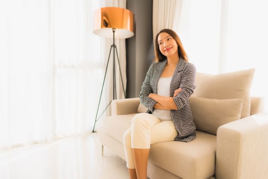 Portrait beautiful young asian women happy smile relax sitting on sofa chair photo