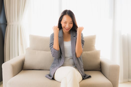 Portrait beautiful young asian women happy smile relax sitting on sofa chair photo
