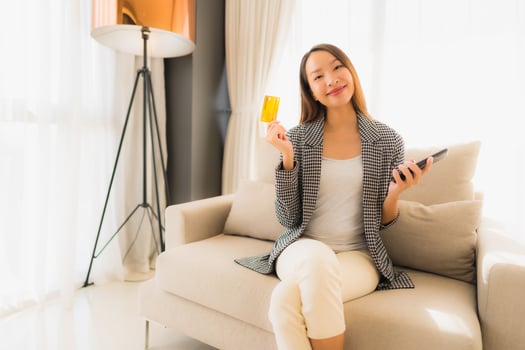 Portrait beautiful young asian women using computer laptop or smart and mobile phone with credit card for online shopping photo