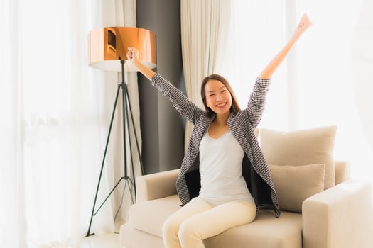 Portrait beautiful young asian women happy smile relax sitting on sofa chair photo