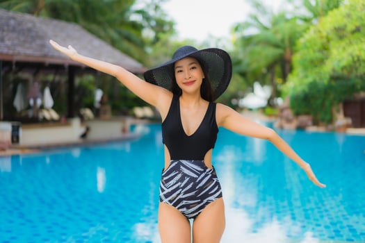 Portrait beautiful young asian women happy smile relax around swimming pool photo