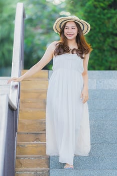 Portrait beautiful young asian woman happy and smile with travel in hotel resort neary sea and beach photo