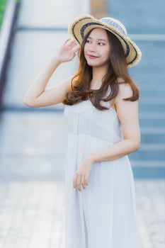 Portrait beautiful young asian woman happy and smile with travel in hotel resort neary sea and beach photo