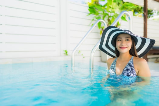Portrait beautiful young asian woman happy smile relax around outdoor swimming pool photo